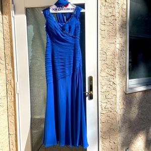 Royal blue gown with ruched and waterfall scarf.